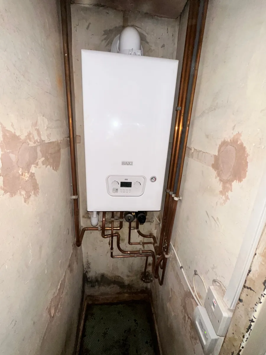 Baxi 400 combi boiler installed in a narrow airing cupboard with neat copper pipework