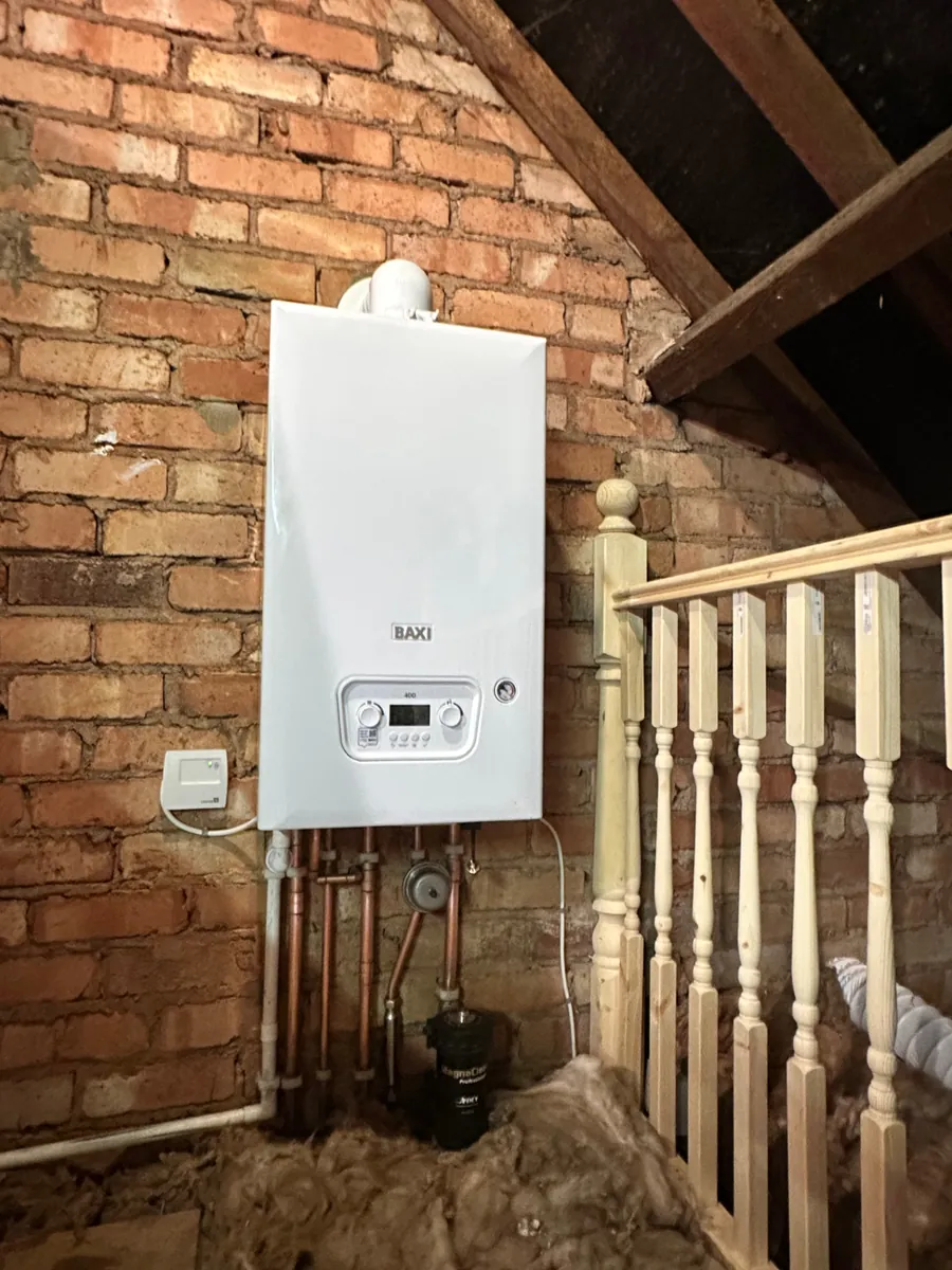 Baxi 400 combi boiler installed in a loft conversion on exposed brickwork with MagnaClean filter